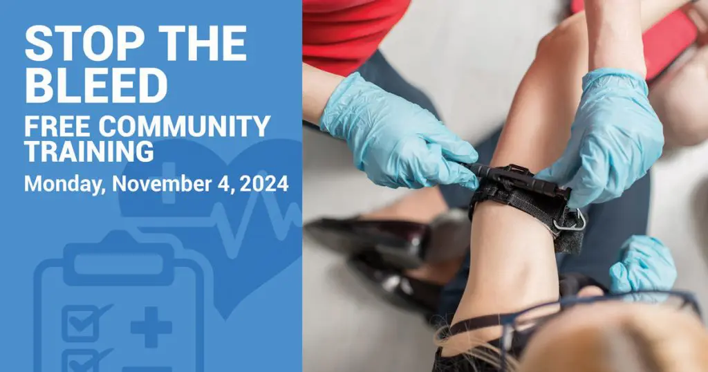 A person in blue gloves is applying a tourniquet to another's arm. Text reads, "Stop the Bleed, Free Community Training at the Resident Resource Fair, Monday, November 4, 2024.