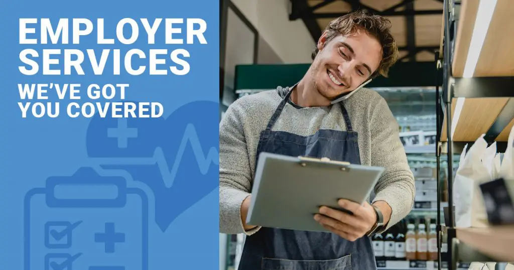 Man in an apron talking on the phone and holding a clipboard, with a blue banner saying Employer Services Weve Got You Covered in the background, ensuring your workforces health is our priority.