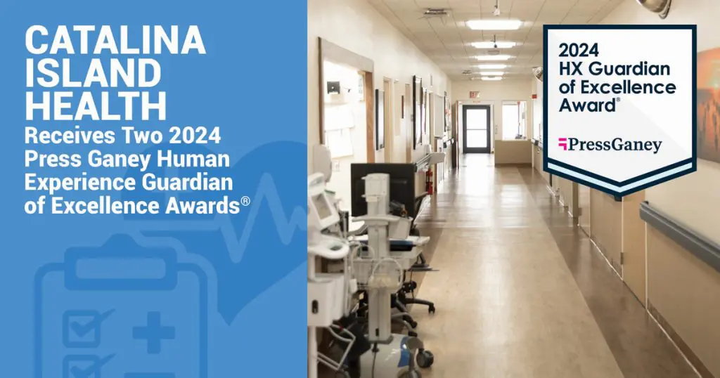 A hospital hallway featuring a blue panel proudly announces Catalina Island Healths remarkable achievement: receiving two 2024 Press Ganey Human Experience Guardian of Excellence Awards.